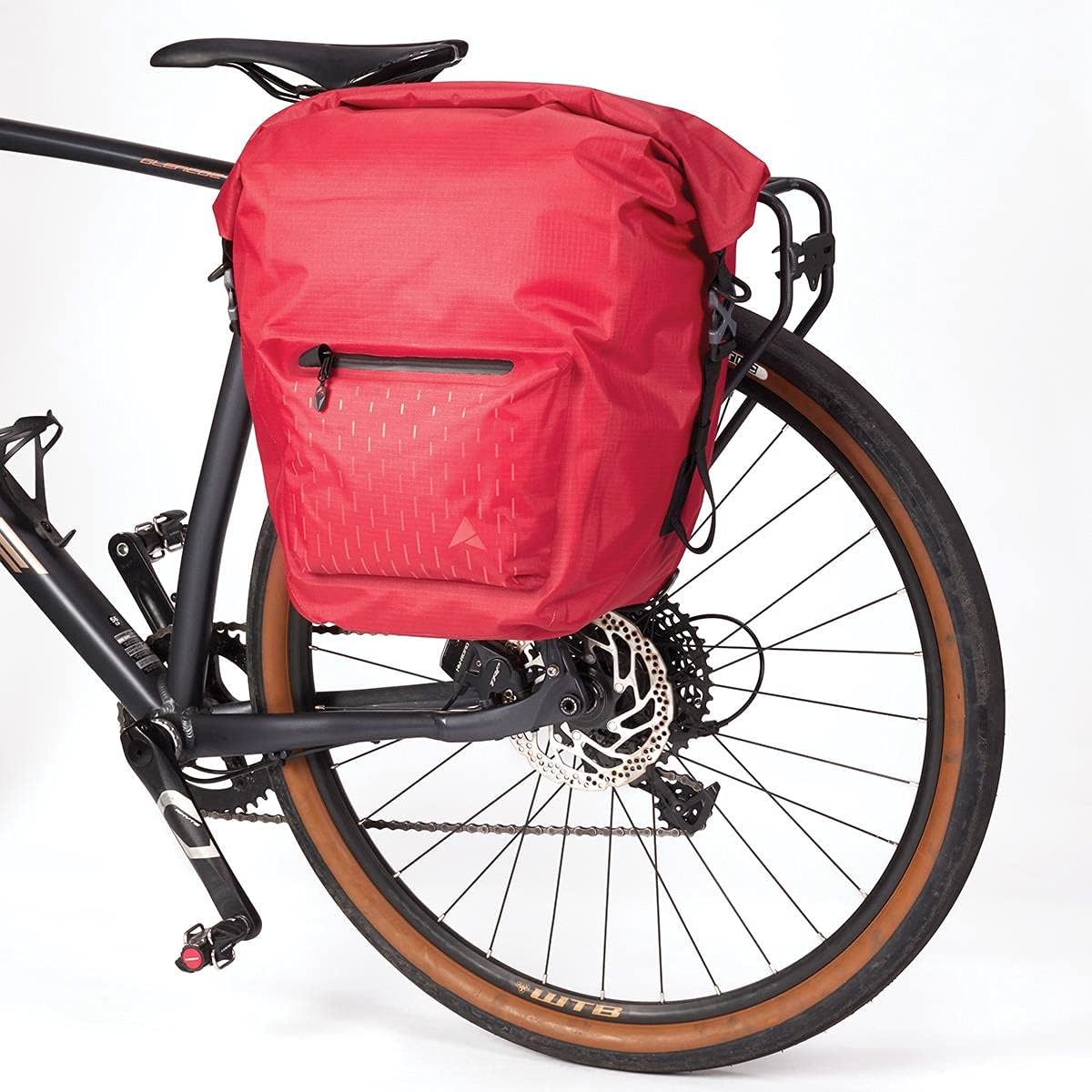 Red 25L Thunderstorm Adventure Pannier Bag with waterproof welded seam construction, roll closure, universal rail pannier fittings, front pocket, and reflective print. Easy to mount and durable for all your adventures.
