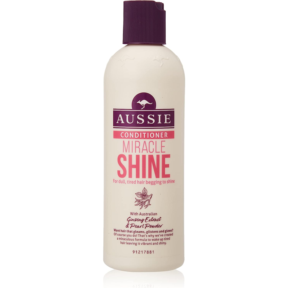 Aussie Conditioner Miracle Shine for Dull Tired Hair, 250ml 6 Pack - White bottle with purple cap, featuring a nourishing formula that adds a super boost of shine to dull hair. Energize your tresses with Australian Ginseng extract and Pearl powder extract for vibrant, glossy strands. Give your hair the bling-bling it deserves with this brilliant shine collection.