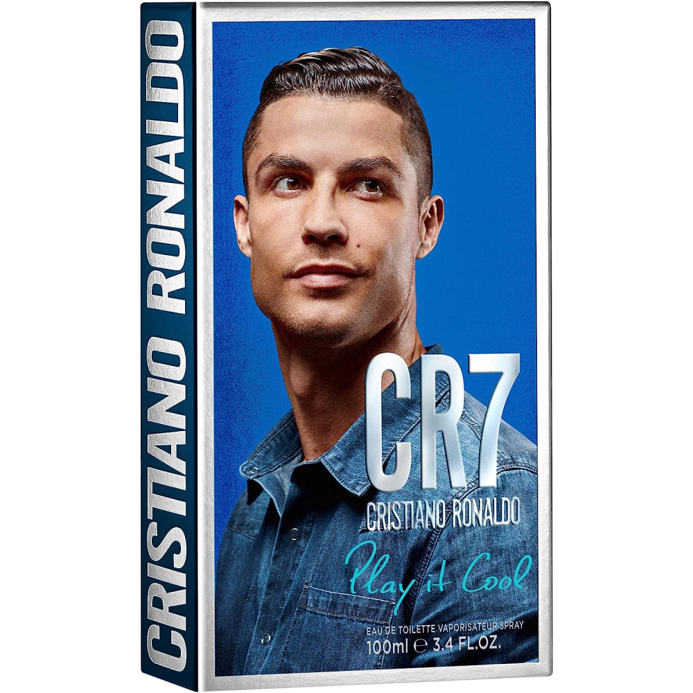 Man wearing a blue shirt holding CR7 Cristiano Ronaldo Play It Cool Eau De Toilette bottle.