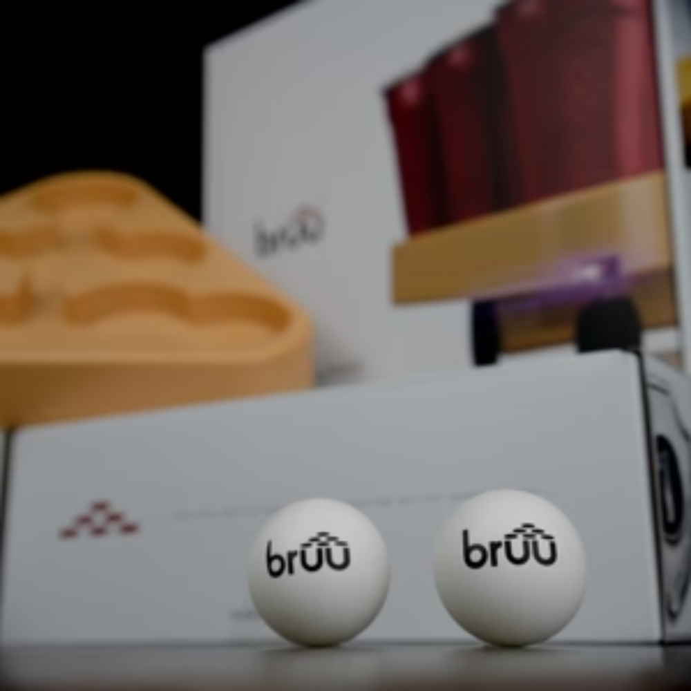 A fun and interactive beer pong robot, BRUU Moving Beer Pong Robot, drives around the table with cups as moving targets. This robot is equipped with custom sensors to ensure stability and prevent collisions. It offers 3 different speeds for an exciting game. Each box contains 1 Robot, 2 Ping Pong Balls, and 1 Quick start guide. Spice up your traditional beer pong matches with this innovative invention!