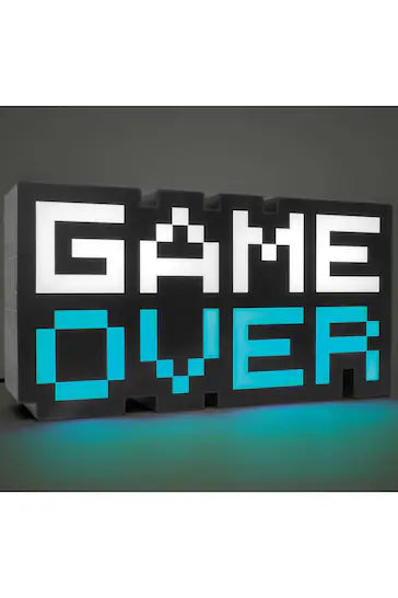8-Bit Pixel Game Over Light - Black and White Sign with Blue Lights. A retro-cool homage to the 8-bit gaming era, this Game Over Light is a must-have for gamers of all ages. Standing at 30cm wide, the black and white sign features a classic pixelated "Game Over" message in blue lights. The "Over" part of the light changes color, cycling from red to blue to green to purple, while the "Game" remains white. Powered by USB (USB cable included), this distinctive and recognizable gaming-themed light is the perfec